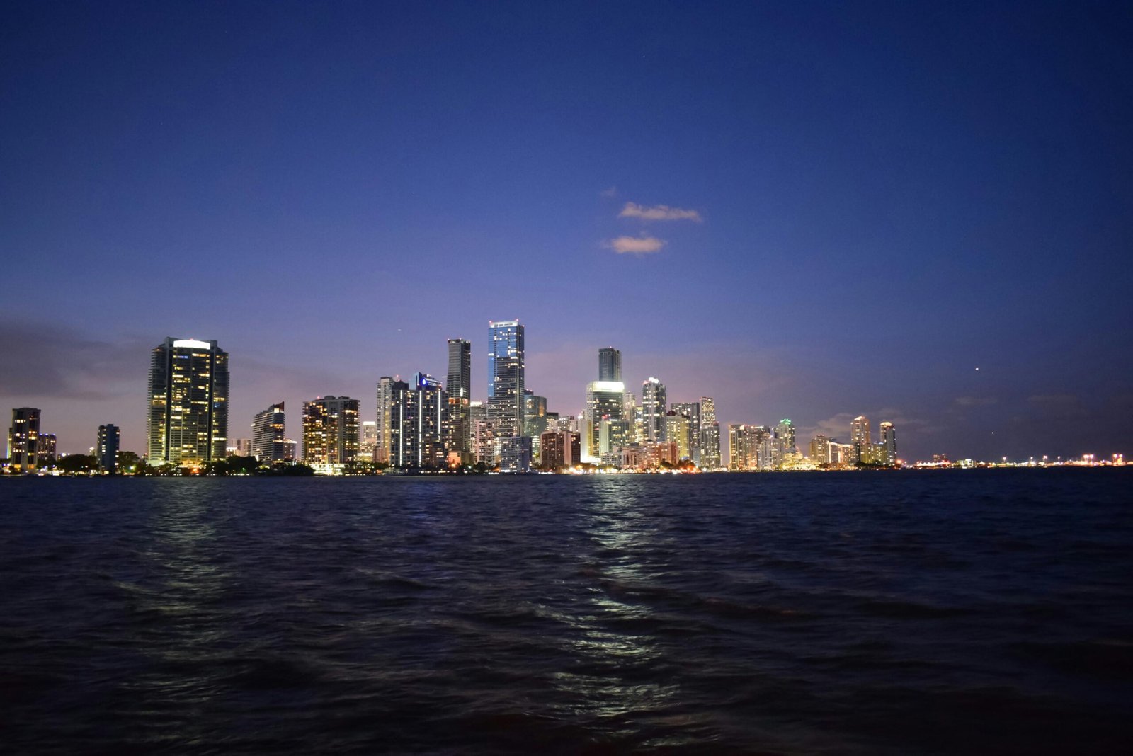 Breathtaking view of Miami's skyline reflecting on Biscayne Bay at twilight.